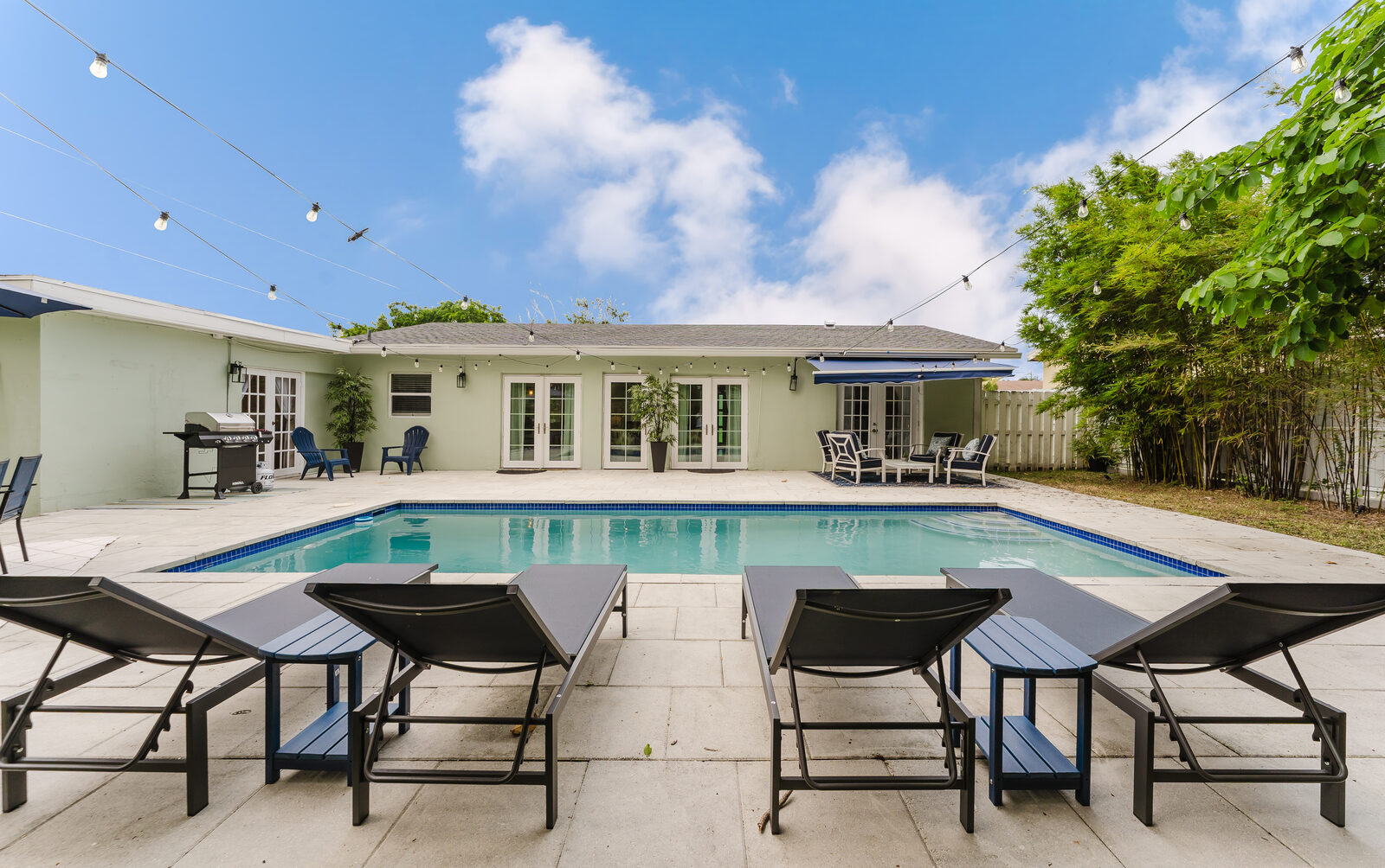Pool lounge chairs facing the house